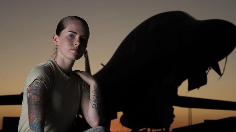 Senior Airman Autumn Rosado, 9th Aircraft Maintenance Unit avionics technician and a tattoo artist in her off-duty time, shows off her tattoos in front of a B-1B Lancer at Dyess Air Force Base, Texas, Sept. 18, 2019. A newly released Air Force regulation now allows airmen limited neck and hand tattoos. (River Bruce/U.S. Air Force)