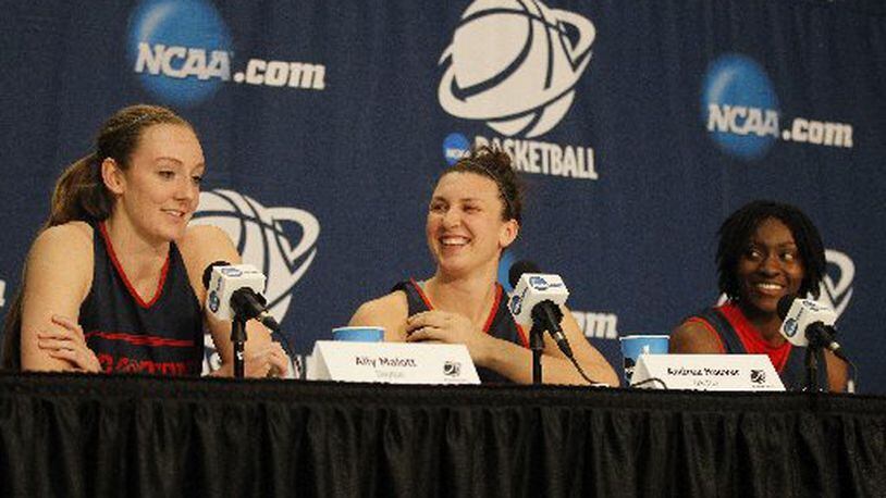 Dayton seniors Ally Malott, left, Andrea Hoover, center, and Tiffany Johnson laugh at a question during a press conference before practice on Friday, March 27, 2015, at the Times Union Center in Albany, N.Y. David Jablonski/Staff