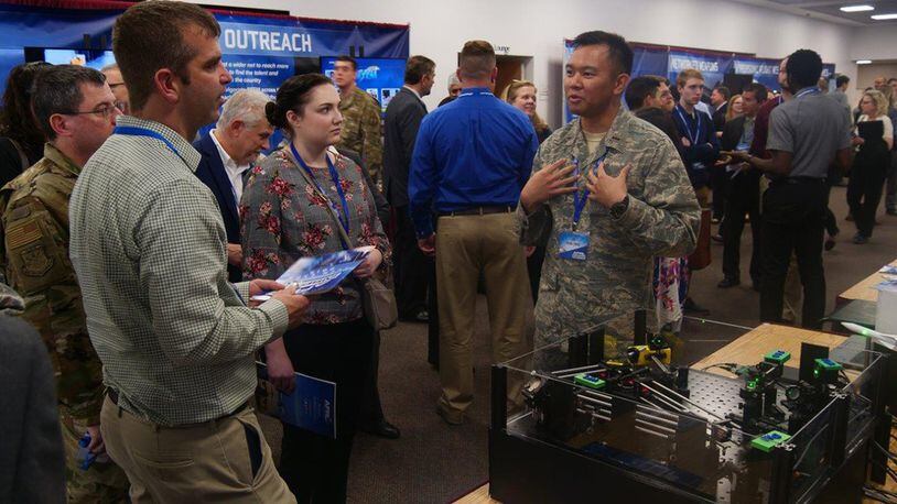 2nd Lt. J.D. Vela Cruz, a laser weapons and aerodynamics engineer from the Air Force Research Laboratory’s Directed Energy Directorate, explains how directed energy amplifies speed, range, precision and accuracy to attendees at the AFRL 2019 Tech Expo event. (U.S. Air Force photo/Kevin Lewis)