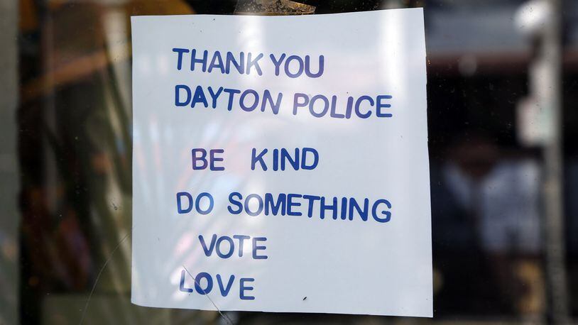 Signs supporting the Dayton Police Department can be found throughout the Oregon District, including this window sign at Feathers. TY GREENLEES / STAFF Signs supporting the Dayton Police Department can be found throughout the Oregon District, including this chalkboard sign at Heart Mercantile. TY GREENLEES / STAFF
