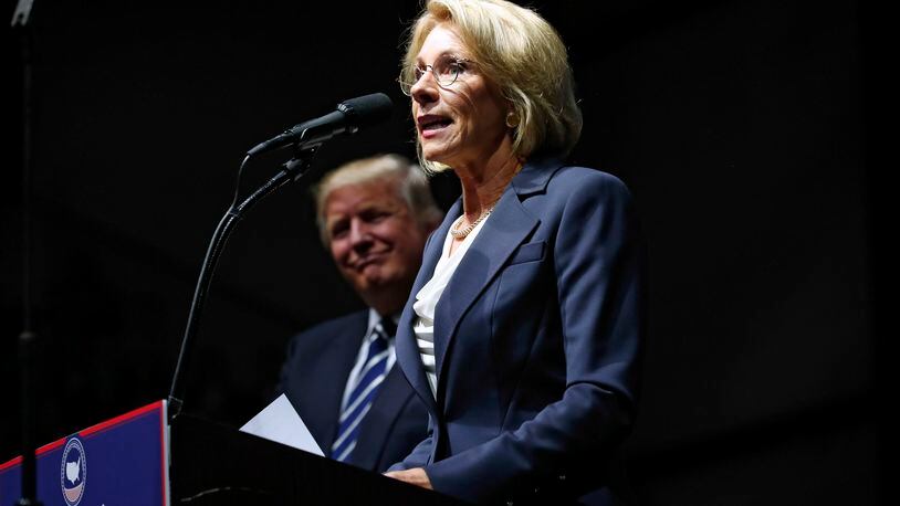 Betsy DeVos, Donald Trump’s nominee for secretary of education, speaks while on stage with the President-elect at a rally in Grand Rapids, Mich., Dec. 9, 2016. Issues related to DeVos’s wealth, power and influence with lawmakers and stance towards teachers unions and the LGBT community swirl around her nomination. (Doug Mills/The New York Times)