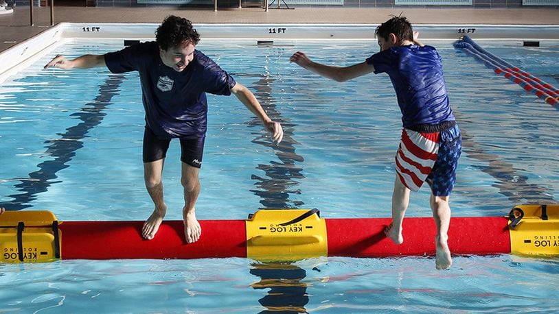 Members of the Catholic Chapel Youth Group give the sport of log rolling a try at the Dodge Gym pool, Wright-Patterson Air Force Base, Ohio, Jan. 14, 2017. Log rolling is growing in popularity across the U.S. especially in youth and collegiate aquatic programs (U.S. Air Force photo/Jim Varhegyi)