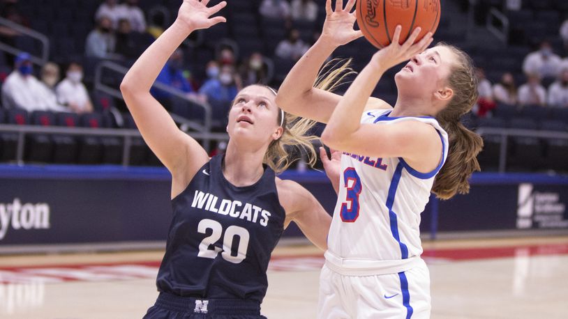Carroll's Sarah Ochs puts up a shot against Napoleon's Taylor Strock during a Division II state semifinal game at UD Arena on Friday, March 12, 2021. Jeff Gilbert/CONTRIBUTED