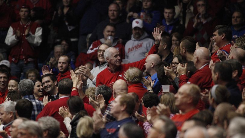 Former Dayton coach Don Donoher waves to the crowd during a game against St. Joseph’s on Thursday, Feb. 19, 2015, at UD Arena. David Jablonski/Staff
