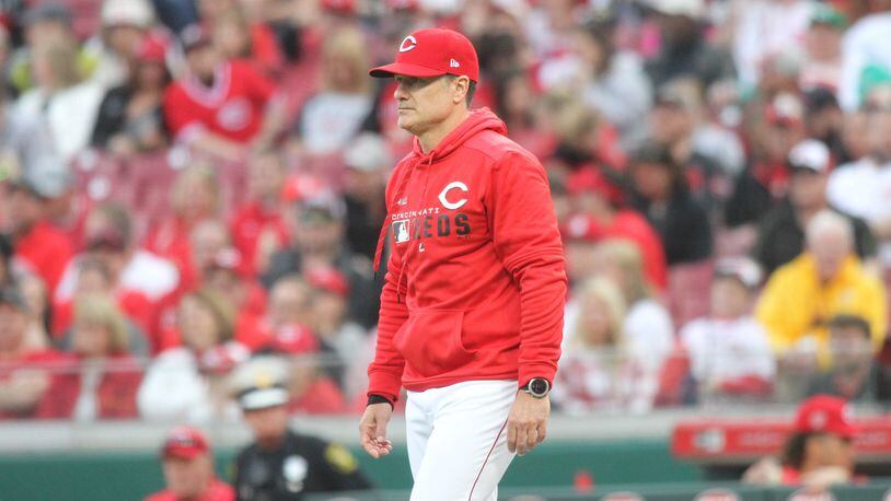 Reds manager David Bell walks to the mound to make a pitching change in the ninth inning against the Pirates on Opening Day on Thursday, March 28, 2019, at Great American Ball Park in Cincinnati. David Jablonski/Staff