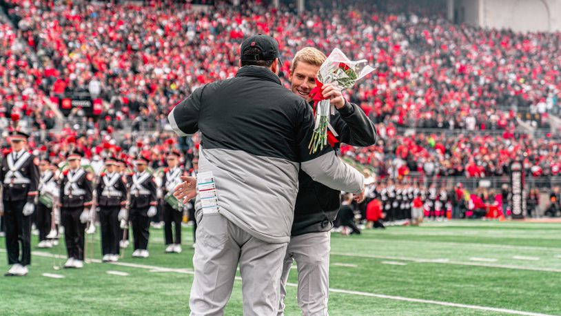 Ohio State football manager Austin Edwards of Springboro hugs head coach Ryan Day in middle of Ohio Stadium on Senior Day. CONTRIBUTED