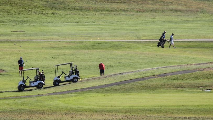 Golfers dotted the Community Golf Course in Kettering on a warm autumn afternoon. During COVID-19, many area golf courses stayed open but limited their services. JIM NOELKER/STAFF