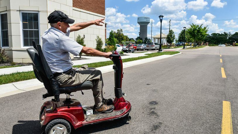 Lynn “Popcorn” Weber rides his scooter around the Otterbein Senior Life campus, where he was a resident in 1959 at Otterbein Childrens Home.