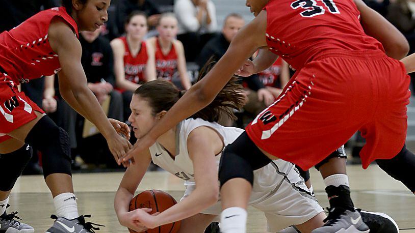 Lakota East guard Lily Rupp dives on a loose ball in front of Lakota West’s Bryana Henderson (left) and Nevaeh Dean during their game in Liberty Township on Dec. 14. West won 68-12. CONTRIBUTED PHOTO BY E.L. HUBBARD