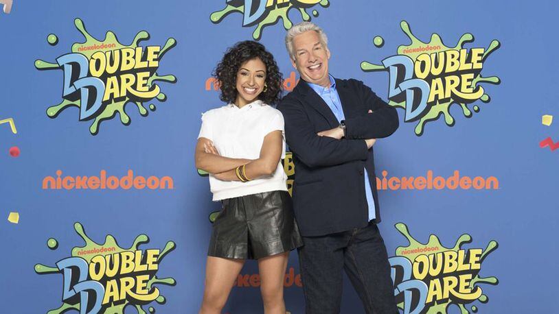 YouTuber and actress Liza Koshy, left, poses with original "Double Dare" host Marc Summers. Koshy is hosting Nickelodeon's reboot of the series. (Photo by Gavin Bond/Nickelodeon)