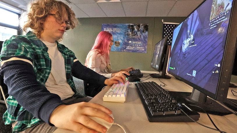 Regan Herzog, left, and Elise Hess, students at the Gobal Impact STEM Academy, play computer games in the school's esports computer lab Thursday, Feb. 2, 2023. BILL LACKEY/STAFF