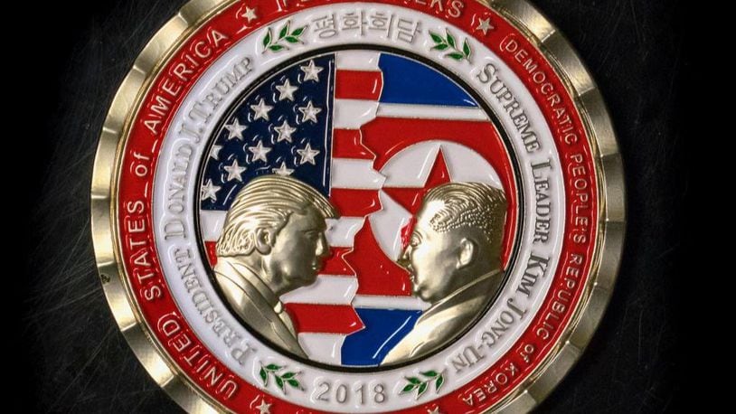 A coin for the US-North Korea summit is seen in Washington, DC, on May 21, 2018. - A commemorative coin featuring US President Donald Trump and North Korea's Kim Jong Un has been struck by the White House Communications Agency ahead of their summit meeting. The coin depicts Trump and Kim, described as North Korea's "Supreme Leader," in profile facing each other in front of a background of US and North Korean flags. The words "Peace Talks" are emblazoned at the top of the front of the coin with the date "2018" beneath. The summit is expected to take place in Singapore on June, 12, 2018. (Photo by STR / AFP)        (Photo credit should read STR/AFP/Getty Images)