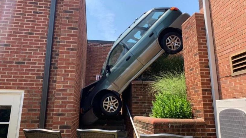 A crash caused a vehicle to become wedged between buildings at a Pennsylvania retirement home, authorities sad.