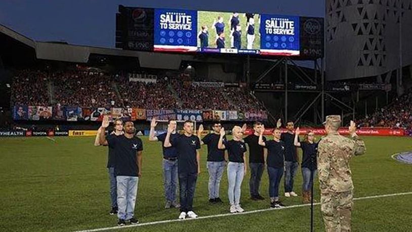 Col. Thomas Sherman, 88th Air Base Wing and installation commander, Wright-Patterson Air Force Base, delivers the oath of enlistment to 10 participants in the U.S. Air Force’s Delayed Entry Program during halftime at the FC Cincinnati soccer match held at Nipper Stadium Aug. 17. (Courtesy photo/FC Cincinnati)