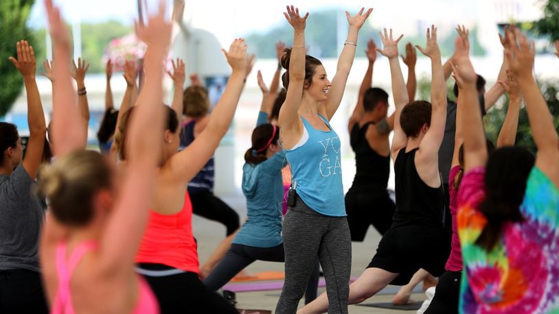 Tori Reynolds, a Dayton area yoga instructor, leads more than 80 people in a yoga class at RiverScape Metro Park. Kettering Health Network will host a Zumba class on Feb. 28 at the Kettering Recreation Complex in Kettering in honor of American Heart Month. LISA POWELL / STAFF