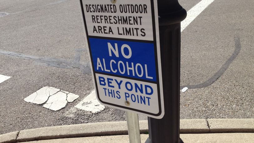 These signs are posted in the Designated Outdoor Refreshment Area in downtown Middletown where open consumption of alcoholic beverages are permitted. The city of Middletown extended the DORA district hours on Saturday for the St. Patrick’s Day celebration. FILE PHOTO