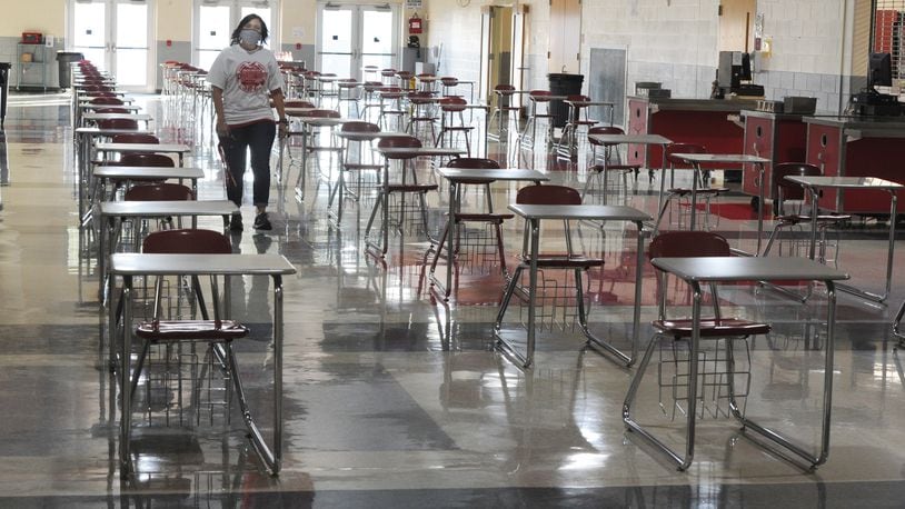 Stebbins High School Principal Tina Simpson, walks through the lunchroom with individual tables that were set up for social distancing. MARSHALL GORBY\STAFF