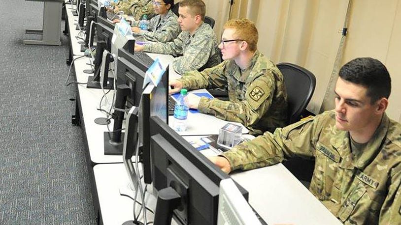 The eyes of Team Alpha’s seven Army and Air Force ROTC cadets are glued to their dual monitors as they prepare their two virtual computer systems’ defenses and navigate network structures during the Air Force Institute of Technology’s Advanced Cyber Education program here. The program hosted 45 Air Force and Army ROTC cadets and split them into seven green-blue teams, putting each team through a wide variety of cybersecurity related disciplines to develop original thinkers and technical leaders who will be prepared to solve real-world problems in the area of cybersecurity. (U.S. Air Force photo/John Van Winkle)