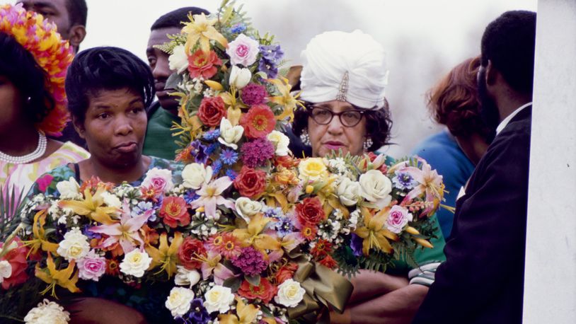 Women hold a funeral bouquet for the Rev. Martin Luther King Jr. at South View Cemetery in Atlanta on April 9, 1968. DECLAN HAUN / CONTRIBUTED BY CHICAGO HISTORY MUSEUM