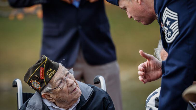 WWII veteran, Ken Snavely, 104-year-old and from Centerville, talks with Chief Master Stg. Jason Shaffer at Leonard Stubbs Memorial Park to honor veterans on Veterans Day Nov. 11, 2021. JIM NOELKER.STAFF