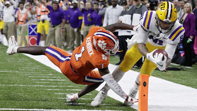 LSU tight end Thaddeus Moss scores a touchdown past Clemson cornerback Derion Kendrick during the second half of a NCAA College Football Playoff national championship game Monday, Jan. 13, 2020, in New Orleans. (AP Photo/Sue Ogrocki)