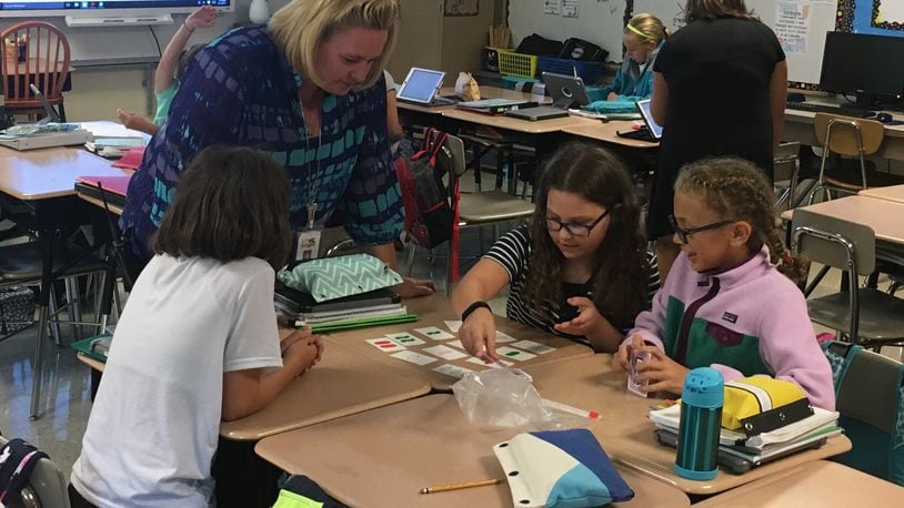 Susan Peveler, principal of Shaw Elementary in Beavercreek, plays a pattern-matching game with fifth-grade students last month. Beavercreek schools earned an “A” for student growth on the state report card. JEREMY P. KELLEY/STAFF