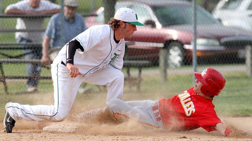 Badin third baseman Heath Stricker tags out Purcell Marian’s Vince Meinking to complete a double play after an out at home plate during a game at Alumni Field on April 30, 2012. JOURNAL-NEWS FILE PHOTO