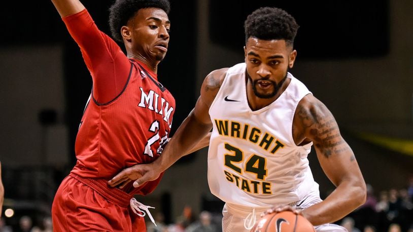 Wright State University’s Mark Alstork dribbles down court defended by Miami Univeristy’s Michael Weathers during the first half of their game against Tuesday, Nov. 15 at the Nutter Center at Wright State University in Fairborn. NICK GRAHAM/STAFF