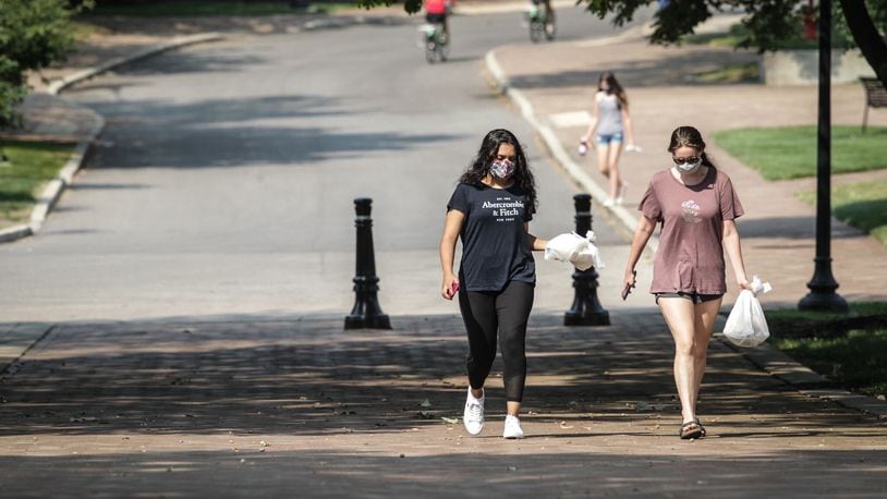 Ayesha Sheikh, left and Brooke Baker, both sophomores at the University of Dayton, wear masks as they walk on campus during the COVID-19 outbreak Wednesday Aug. 26, 2020.