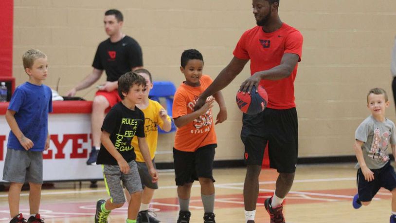 Dayton guard Scoochie Smith works with kids at a youth basketball camp at UD’s Cronin Center on Tuesday, July 19, 2016, in Dayton. David Jablonski/Staff
