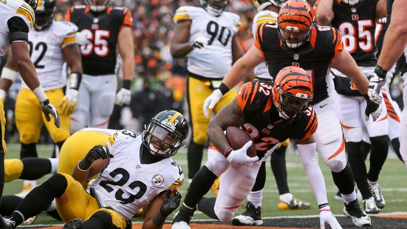 Bengals running back Jeremy Hill (32) runs up the middle for a touchdown during their game against the Steelers at Paul Brown Stadium, Sunday, Dec. 18, 2016. GREG LYNCH / STAFF