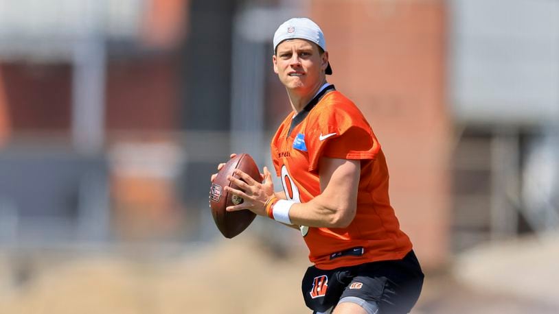 Cincinnati Bengals' Joe Burrow looks to pass as he participates in a drill during an NFL football practice in Cincinnati, Tuesday, May 24, 2022. (AP Photo/Aaron Doster)