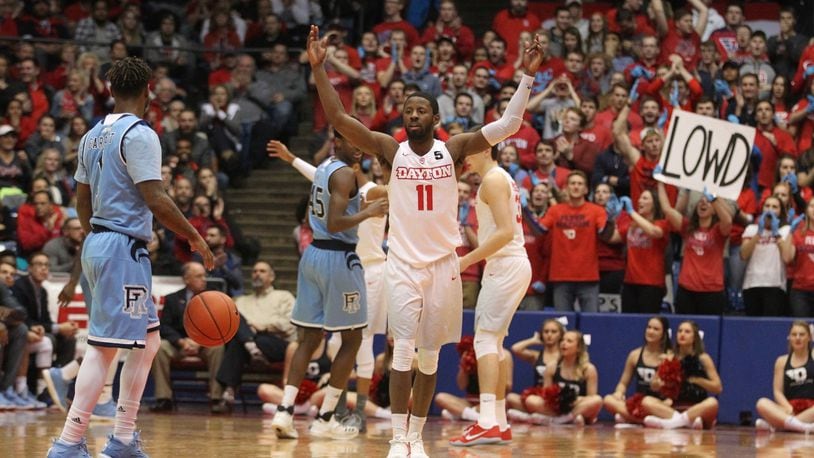 Dayton’s Scoochie Smith tries to pump up the crowd in the second half during a game against Rhode Island on Friday, Jan. 6, 2017, at UD Arena. David Jablonski/Staff