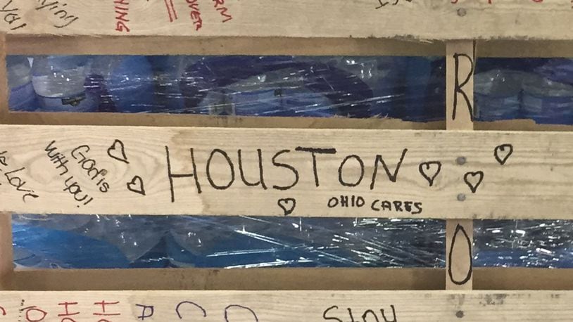 Messages have been left at The Foodbank in Dayton on donated cases of water and pallets bound to victims of Harvey in Texas. SUBMITTED