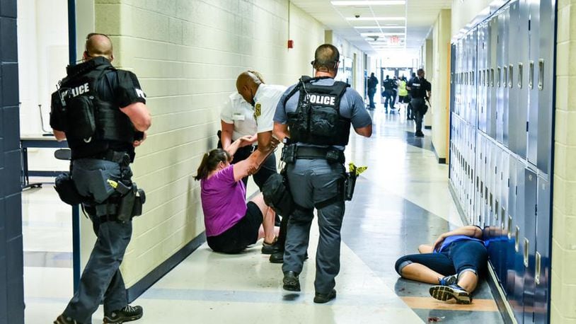 Some school districts - like Hamilton in this photo - have conducted mock, active-shooter attack drills on campus in preparation for upgrading security this school year. NICK GRAHAM/STAFF