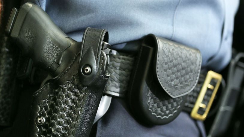 A handgun sits in the holster of a law enforcement officer in a July 2012 file photo.
