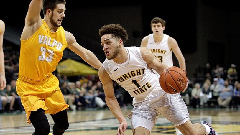 Point guard Justin Mitchell, driving on John Kiser, had seven of Wright State’s 22 turnovers in Saturday’s loss to Valparaiso. TIM ZECHAR / CONTRIBUTED