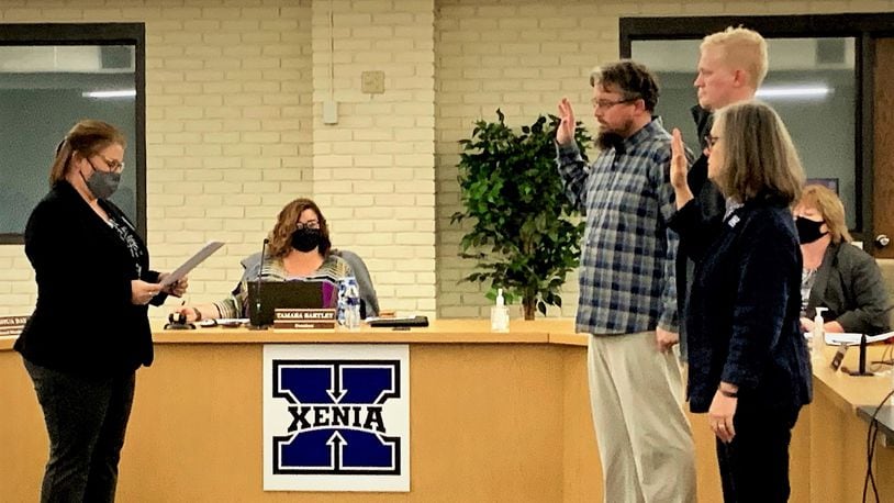 Newly elected Xenia Community Schools board members George Leightenheimer, Josh Day, and Mary Grech are sworn in on Monday.