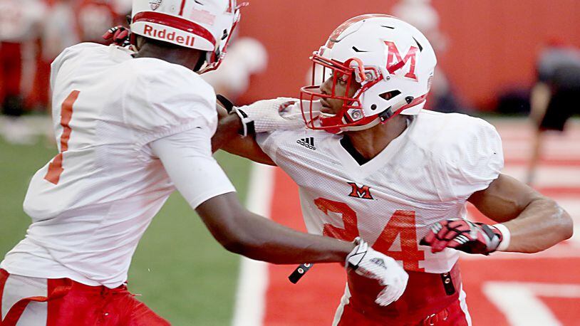 Miami Redhawks defensive back Heath Harding (right) covers teammate Cedric Asseh during practice in Oxford on Wednesday. E.L. HUBBARD/CONTRIBUTED