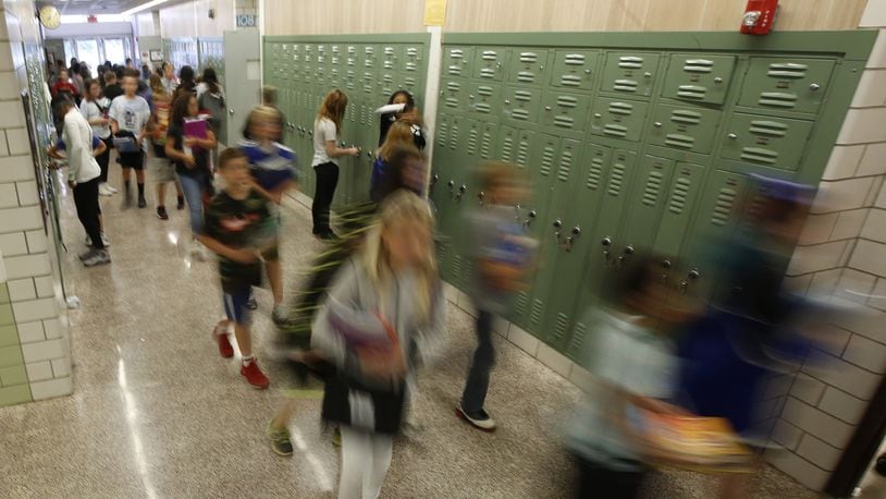 Students walk the halls of Warner Middle School in Xenia, which will soon be replaced by a new school building. TY GREENLEES FILE PHOTO