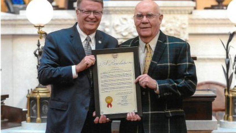 Bob Arledge, left, standing with Ohio Representative Steve Wilson, right, receiving an award after Arledge won the 2018 World Masters Track and Field Championship in the 85-89 division for pole vault. Photo courtesy of Bob Arledge. CONTRIBUTED