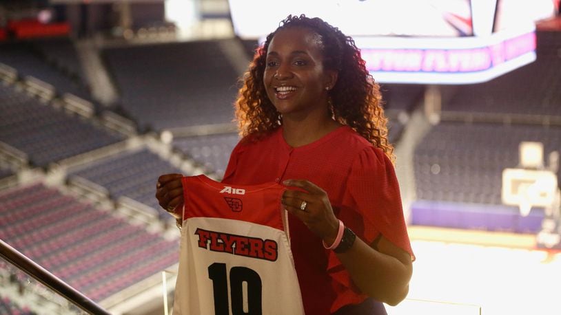 Tamika Williams-Jeter poses for a photo at UD Arena after being introduced as the new Dayton women's basketball coach on Monday, March, 28, 2022. David Jablonski/Staff