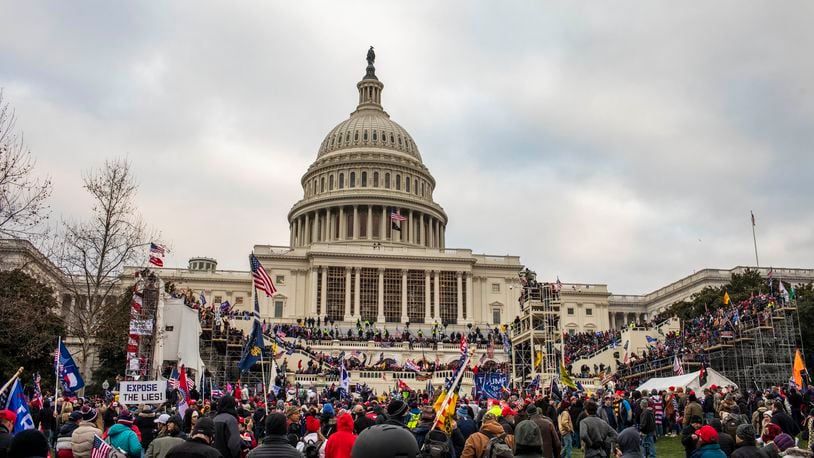 A pro-Trump mob storms the Capitol in Washington after a rally where the president spoke, urging them on, Jan. 6, 2021. Experts say the actions of President Donald Trump and his loyalists are harder to stop than a coup — citing anti-democratic slides in Turkey and Venezuela as closer examples. (Jason Andrew/The New York Times)