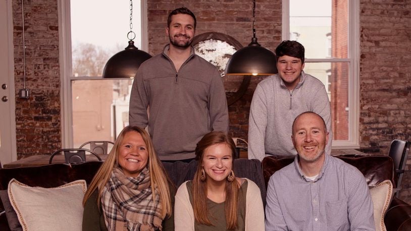 Sarah Pelphrey, bottom left, was nominated as a Dayton Daily News Community Gem. She's pictured here in her downtown Miamisburg loft with her family: sons Dane and Shane, upper left and upper right, daughter Tristen, bottom center, and husband Brian, bottom right. CONTRIBUTED