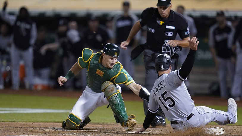 FILE - Oakland Athletics catcher Sean Murphy, left, tries to tag Chicago White Sox's Adam Engel (15), who scored the tying run during the ninth inning of a baseball game in Oakland, Calif., Sept. 9, 2022. The Atlanta Braves acquired catcher Murphy from the Oakland Athletics as part of a three-team deal on Monday, Dec. 12, 2022, that also sent catcher William Contreras to the Milwaukee Brewers. (AP Photo/Godofredo A. Vásquez, File)