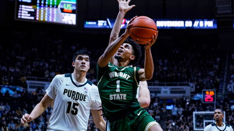 Wright State guard Trey Calvin (1) shoots in front of Purdue center Zach Edey (15) during the first half of an NCAA college basketball game in West Lafayette, Ind., Tuesday, Nov. 16, 2021. (AP Photo/Michael Conroy)