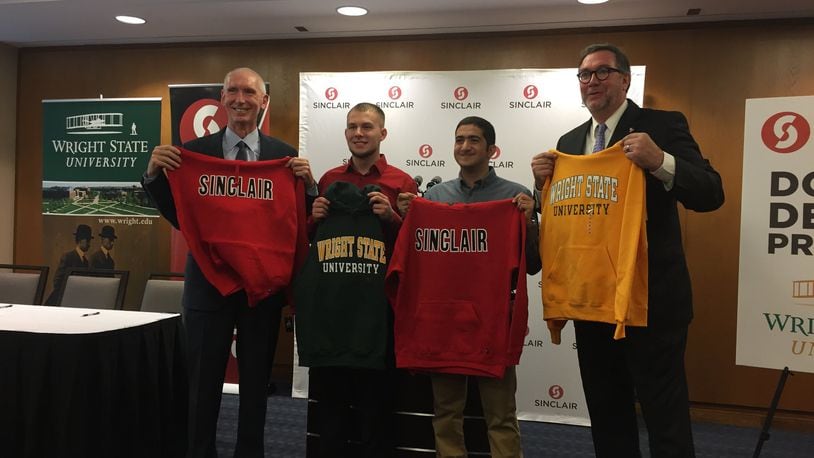 Wright State Provost Tom Sudkamp, left, students Tyler McDonugh and David Bebawy, and Sinclair President Steven Johnson attend an event in honor of the renewal of the Double Degree Program. McDonugh and Bebawy will attend WSU in the fall as part of the program. MAX FILBY / STAFF