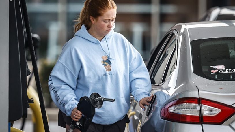 University of Dayton student Megan Doyle pumps gas at the UDF at the corner of Brown and East Stewart streets, Wednesday, April 17, 2024. Per-gallon regular gas at both UDF and Speedway at the intersection is $3.75 a gallon. JIM NOELKER/STAFF