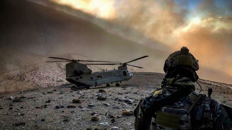 An 83rd Expeditionary Rescue Squadron Airman observes a U.S. Army CH-47 Chinook at an undisclosed location in Afghanistan. The 83rd ERQS is the Air Force Central Commandâ€™s first dedicated joint personnel recovery team, utilizing Air Force Guardian Angel teams and Army CH-47 Chinook crews. (U.S. Air Force courtesy photo)