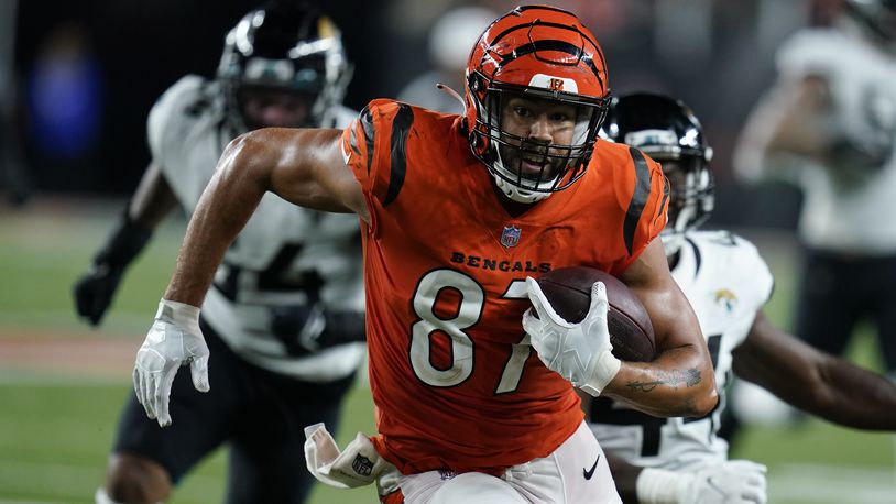 Cincinnati Bengals' C.J. Uzomah (87) goes in for a touchdown during the second half of an NFL football game against the Jacksonville Jaguars, Thursday, Sept. 30, 2021, in Cincinnati. (AP Photo/Michael Conroy)